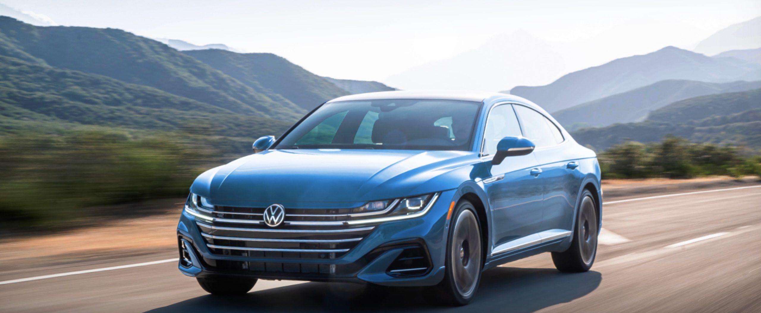 The 20223 VW Arteon driving on a mountain road showcasing the 2023 Volkswagen Arteon specs