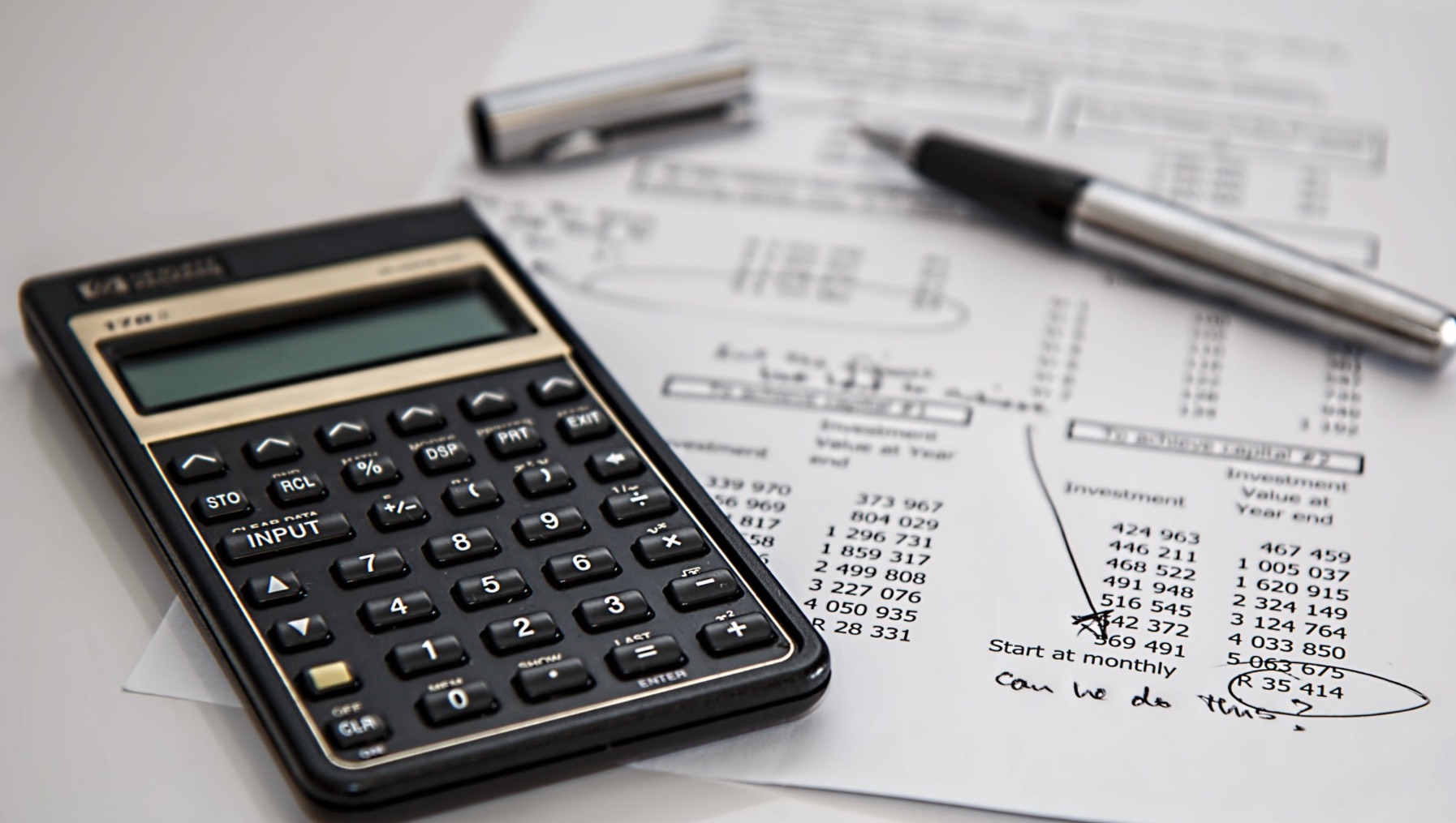 A financing calculator and VW paperwork on a table in Elign, IL.