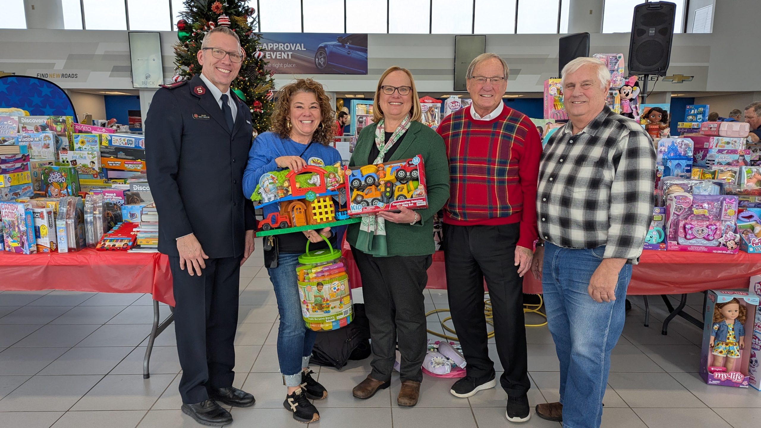 A group of Bachrodt employees standing in front toy toy drive donations