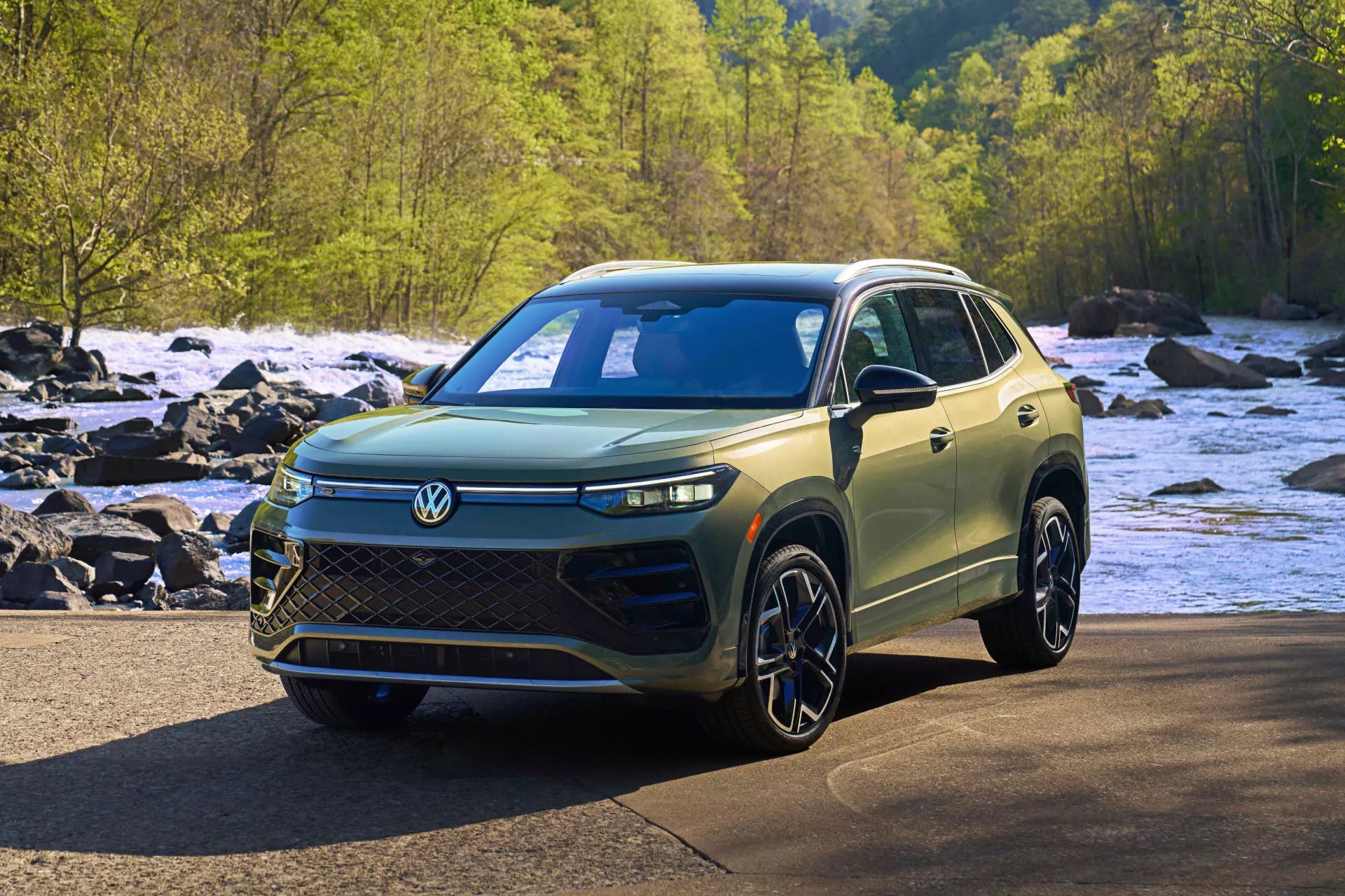 A green 2026 VW Tiguan parked in nature