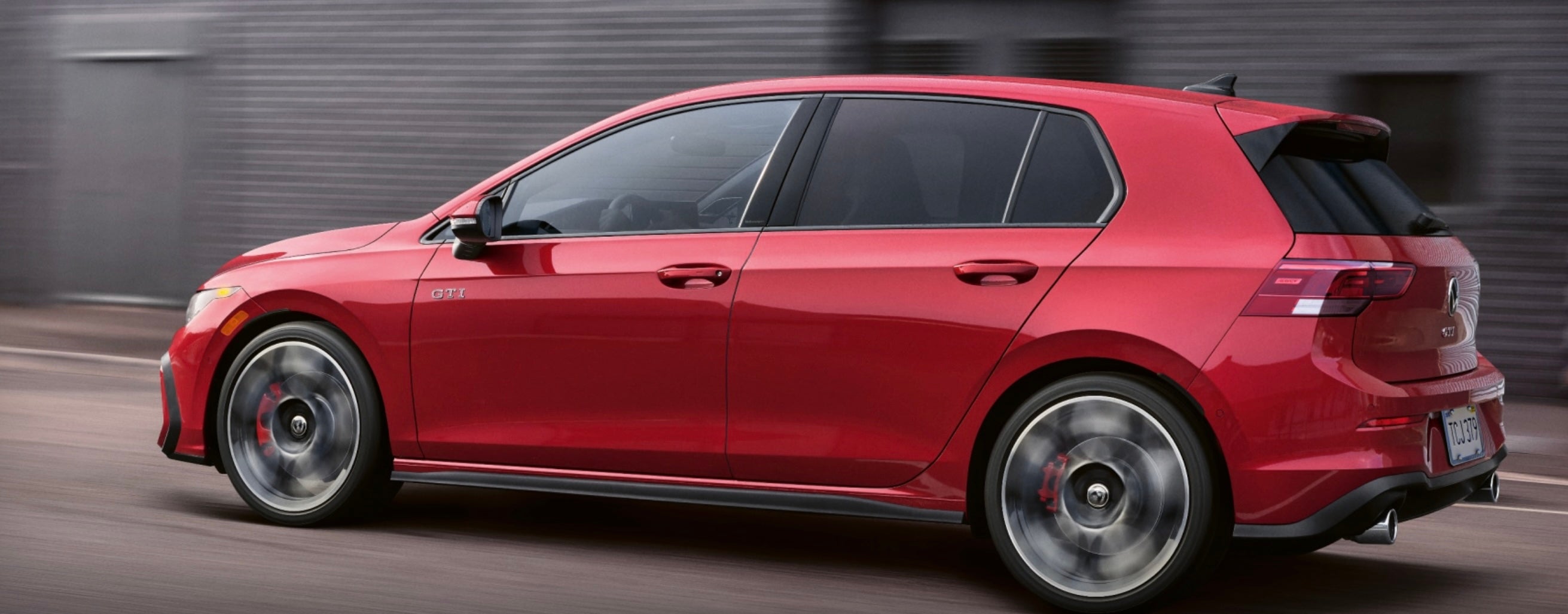 2025 Volkswagen Golf in red driving to Elgin, IL from Rockford, IL