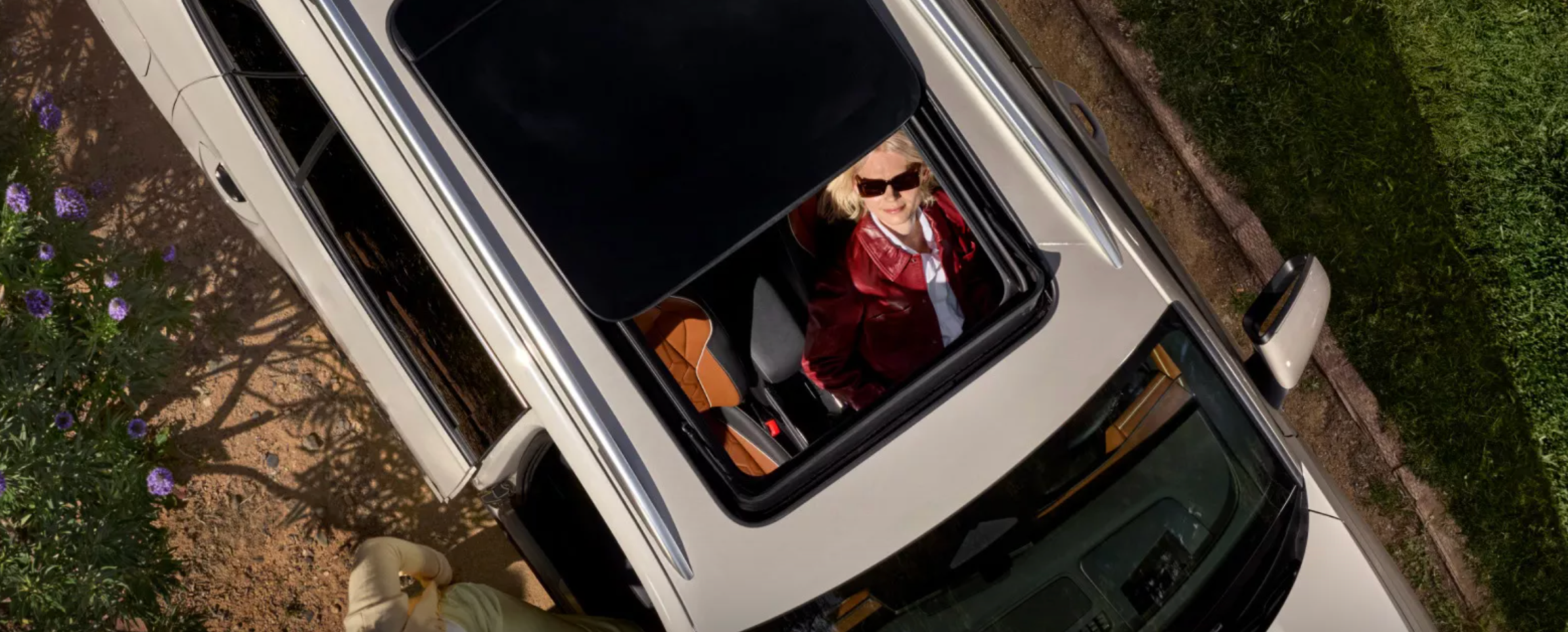 Moonroof view into the Tiguan from a top angle showing a family enjoying a drive through Rockford on a warm, Spring day.