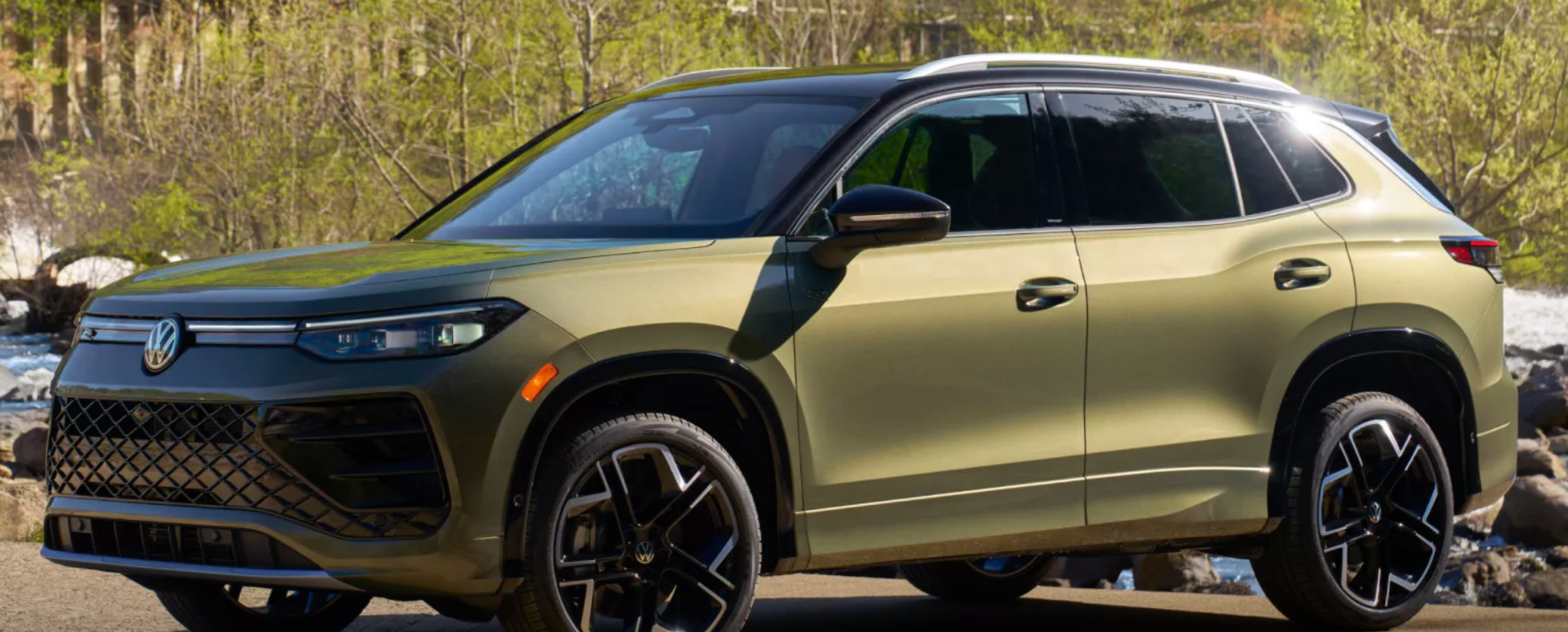 The outside of a new Tiguan parked in a driveway in Rockford, Illinois with a green exterior.