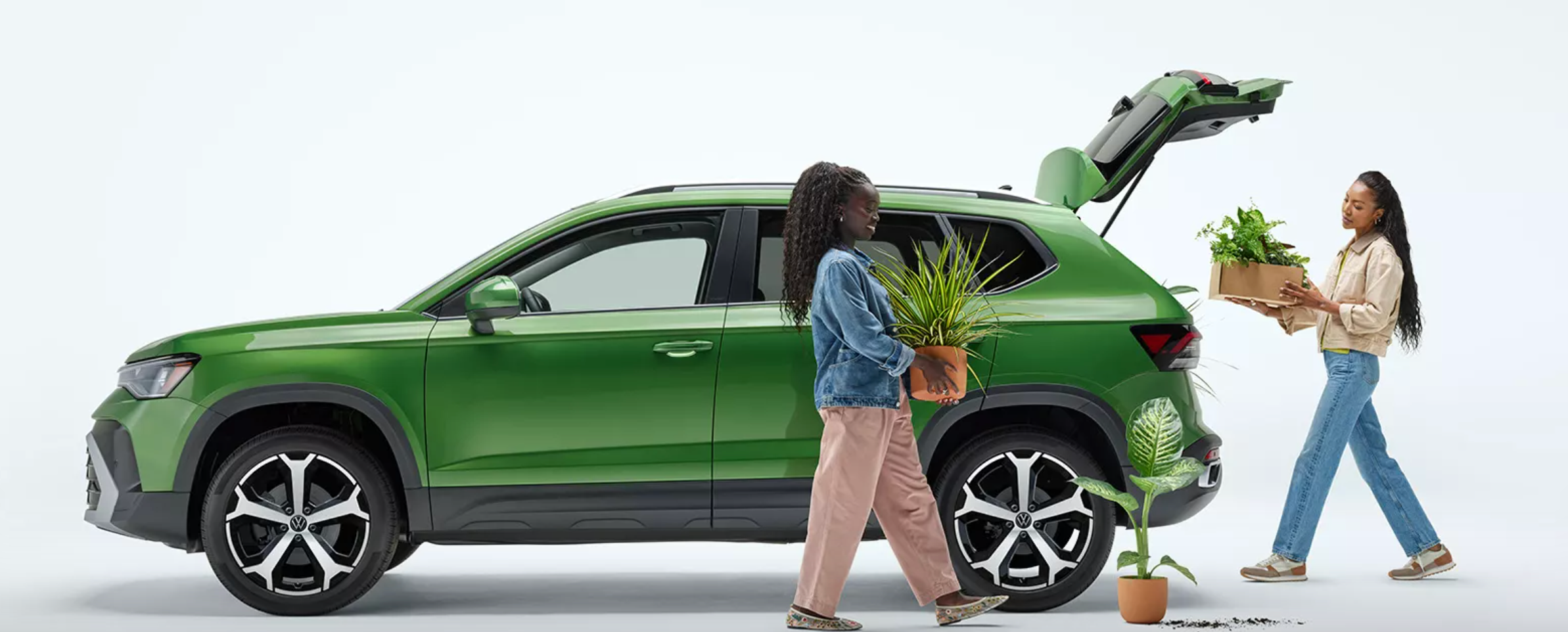 2 women loading plants into the rear hatch of their new VW Taos in Rockford, Illinois.