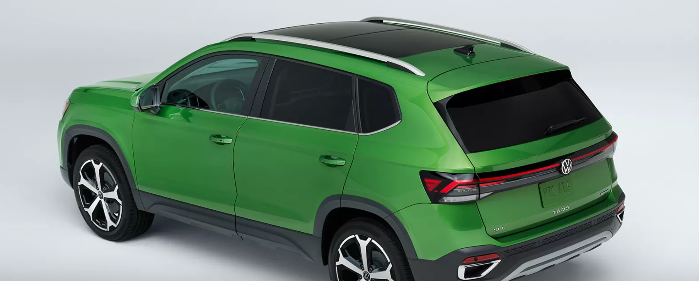 The new VW Taos parked at an angle showcasing the rear to top, left side of the vehicle.
