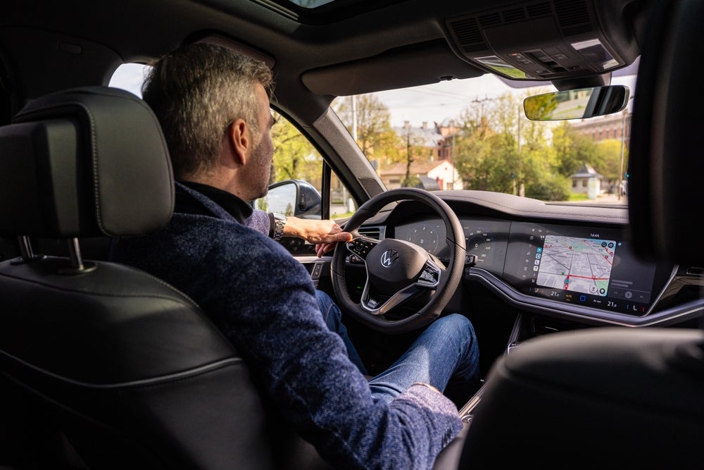 A man driving his new 2024 Volkswagen from Lou Bachrodt Volkswagen